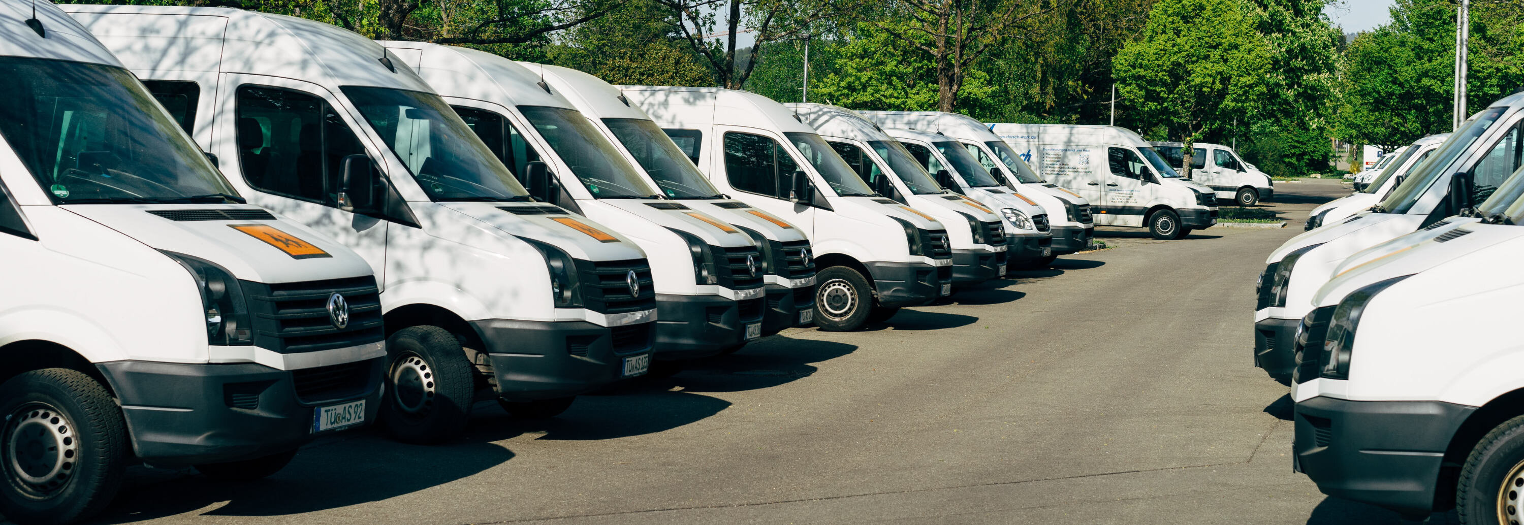 a fleet of vans in a parking lot